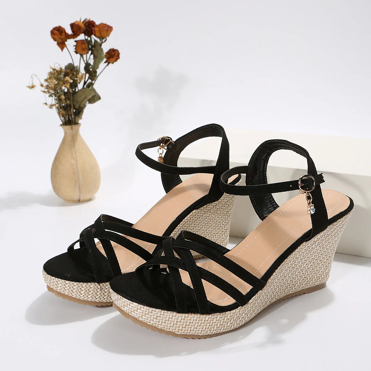 Women's wedge sandals with fish mouth toe design in black cloth material showing wedge heel