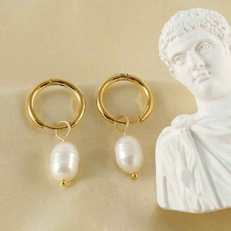 Gold geometric drop earrings for women with a pearl detail on a stainless steel base.