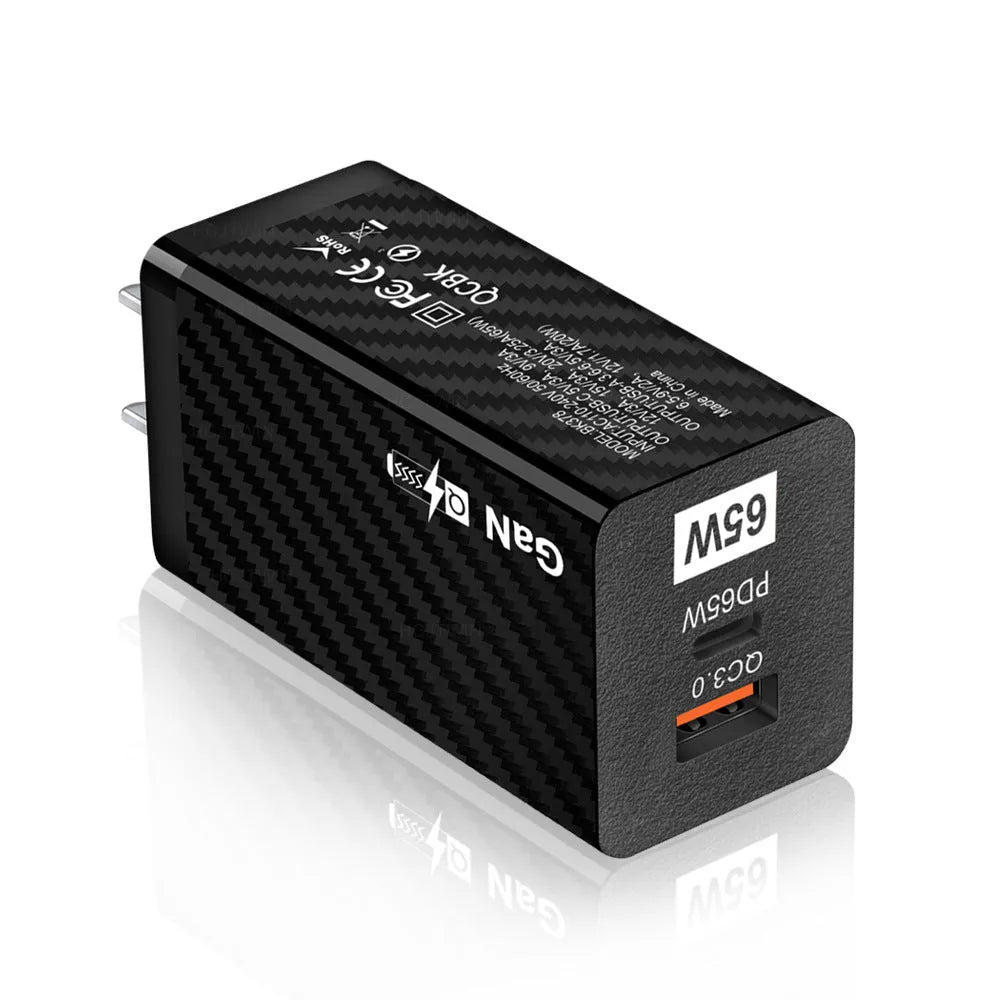 White and black 65W Gallium Nitride USB-PD laptop charger with EU, UK, and US plug options.