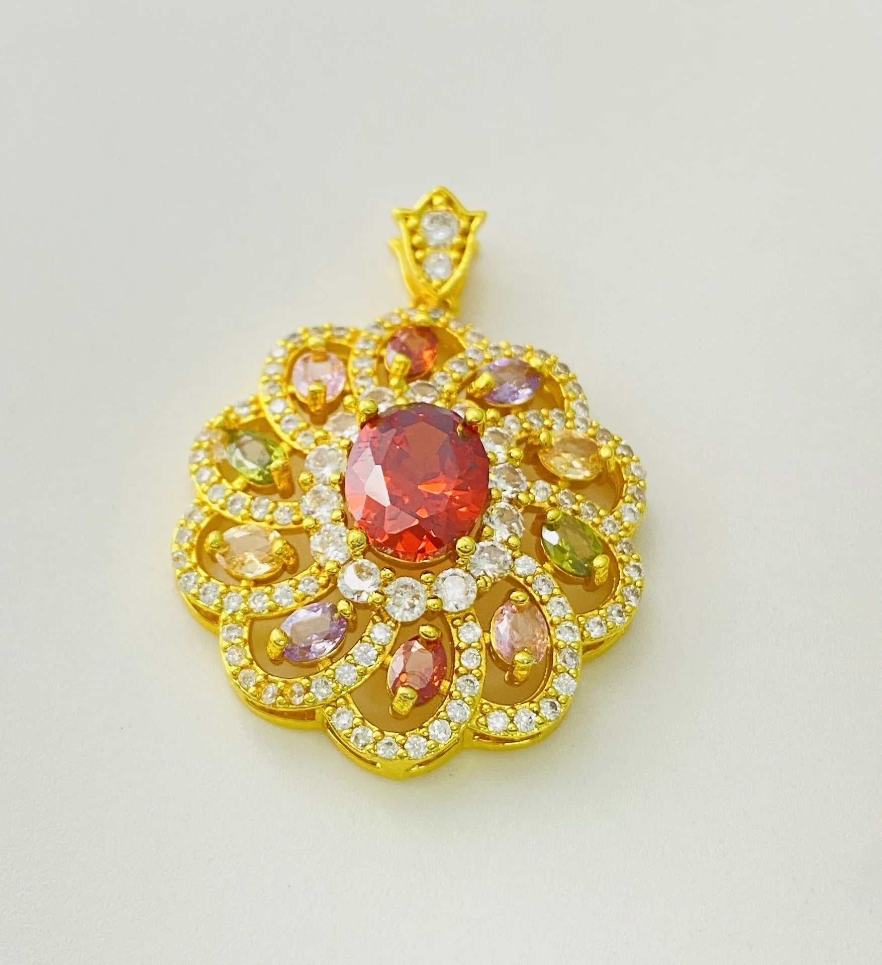 Close-up of a women's flower-shaped zircon pendant necklace in a gold electroplated finish on a model.