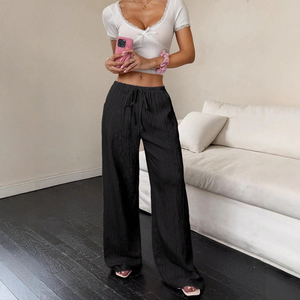 Women's wide-leg trousers with lace-up waist detail in black and pink colour options