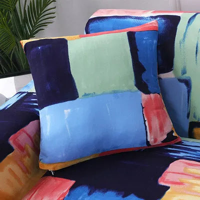 Geometric abstract printed stretch sofa slipcover covering a three-seater sofa with matching cushion covers.