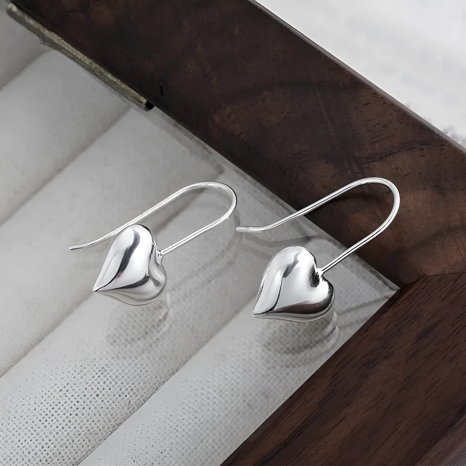 Silver Korean style heart earrings with three-dimensional glossy design and heart-shaped hooks