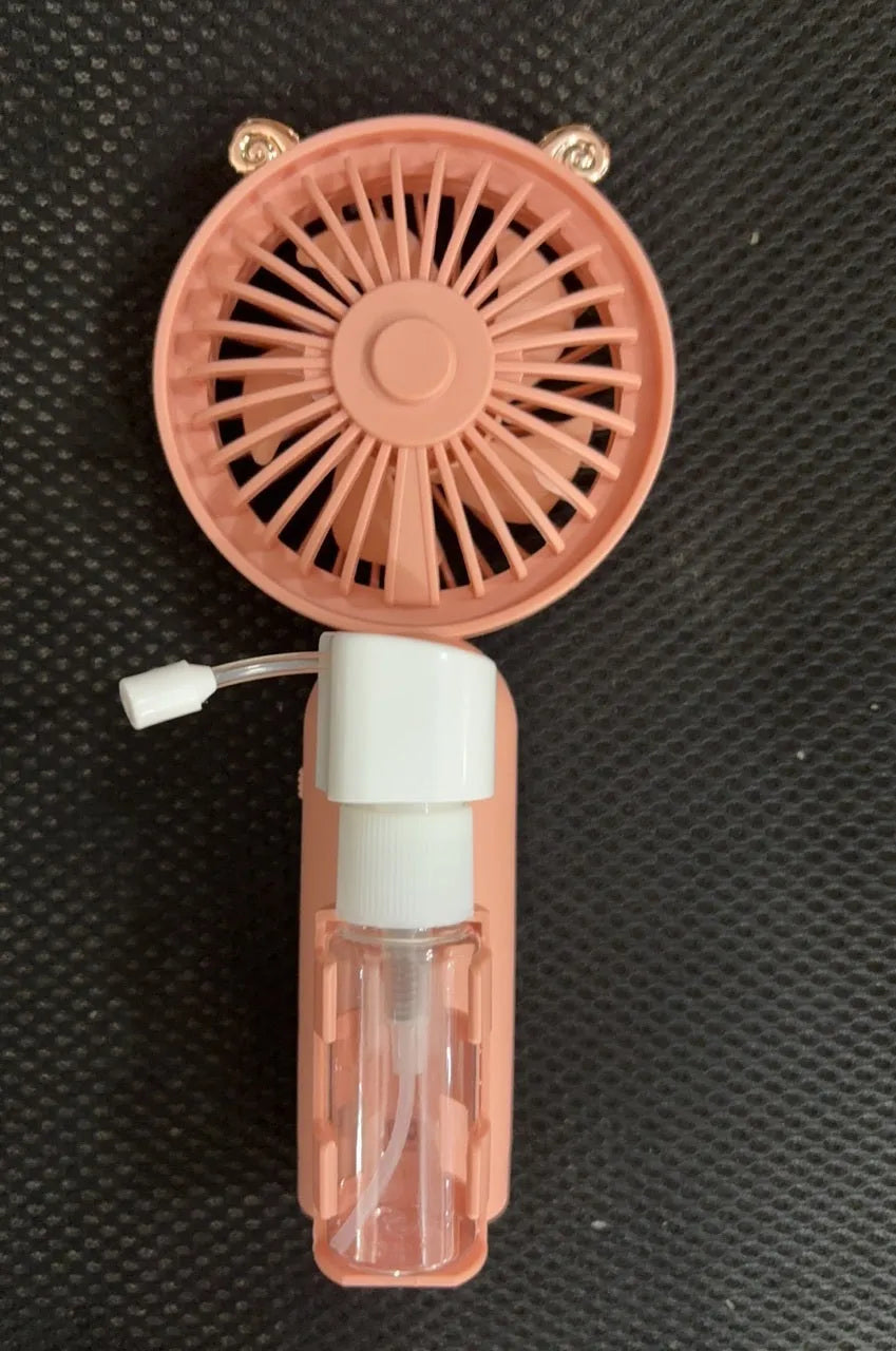 Personalised plastic handheld desk fan with USB port in apricot colour, showing scale.