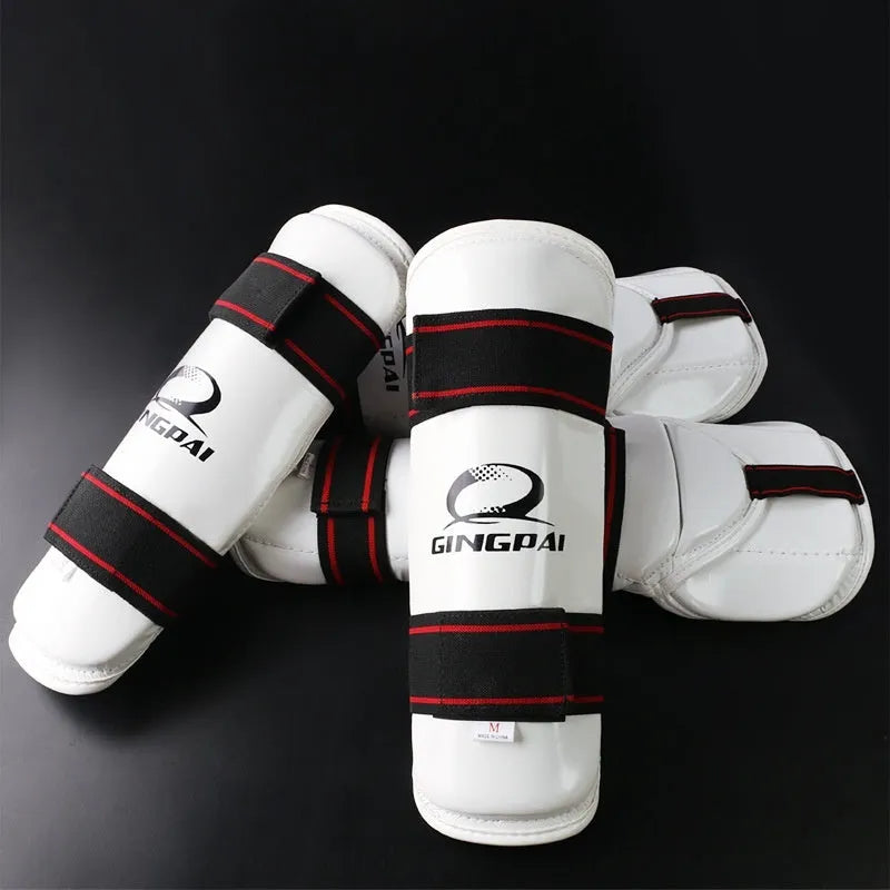 Taekwondo protective gear set showing arm guards, elbow guards, and leg protectors in multiple sizes