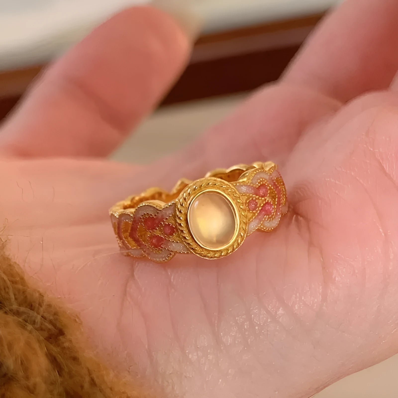 Geometric pink crystal enamel open ring with gold plating showing adjustable design
