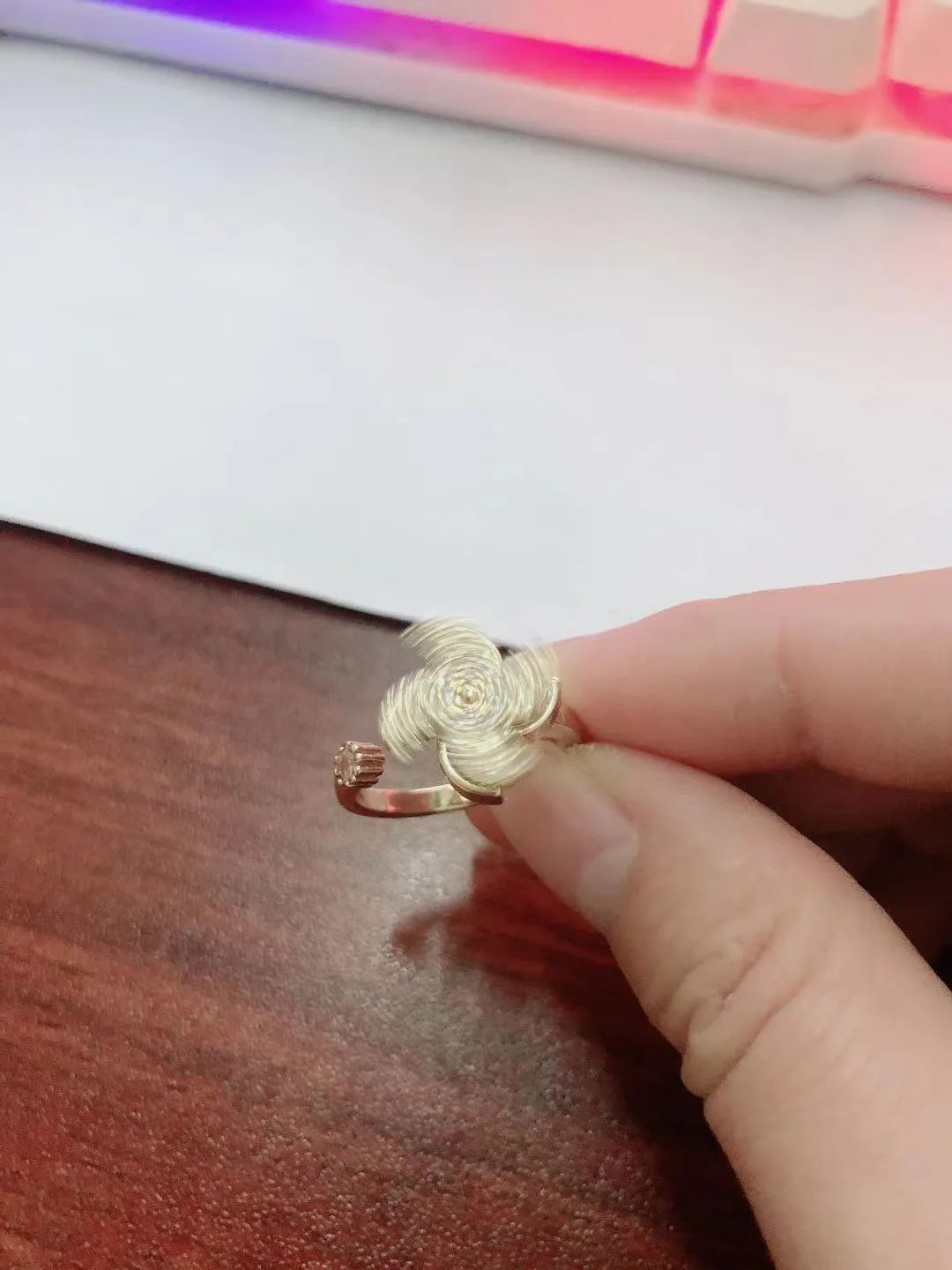 Gold electroplated copper ring with rotating windmill design and micro inlaid geometric detailing