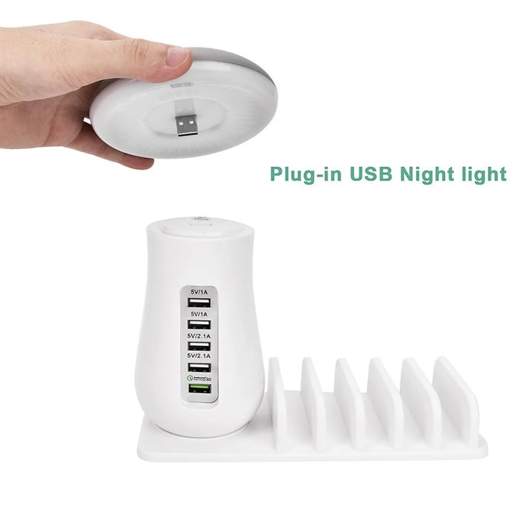 White mushroom-shaped LED desk lamp with a 5-port USB charging dock station at its base on a wooden table