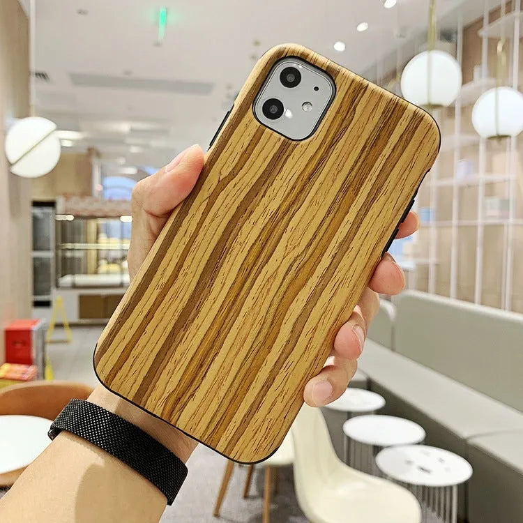 Natural wood grain iPhone back cover case in rosewood finish next to an iPhone