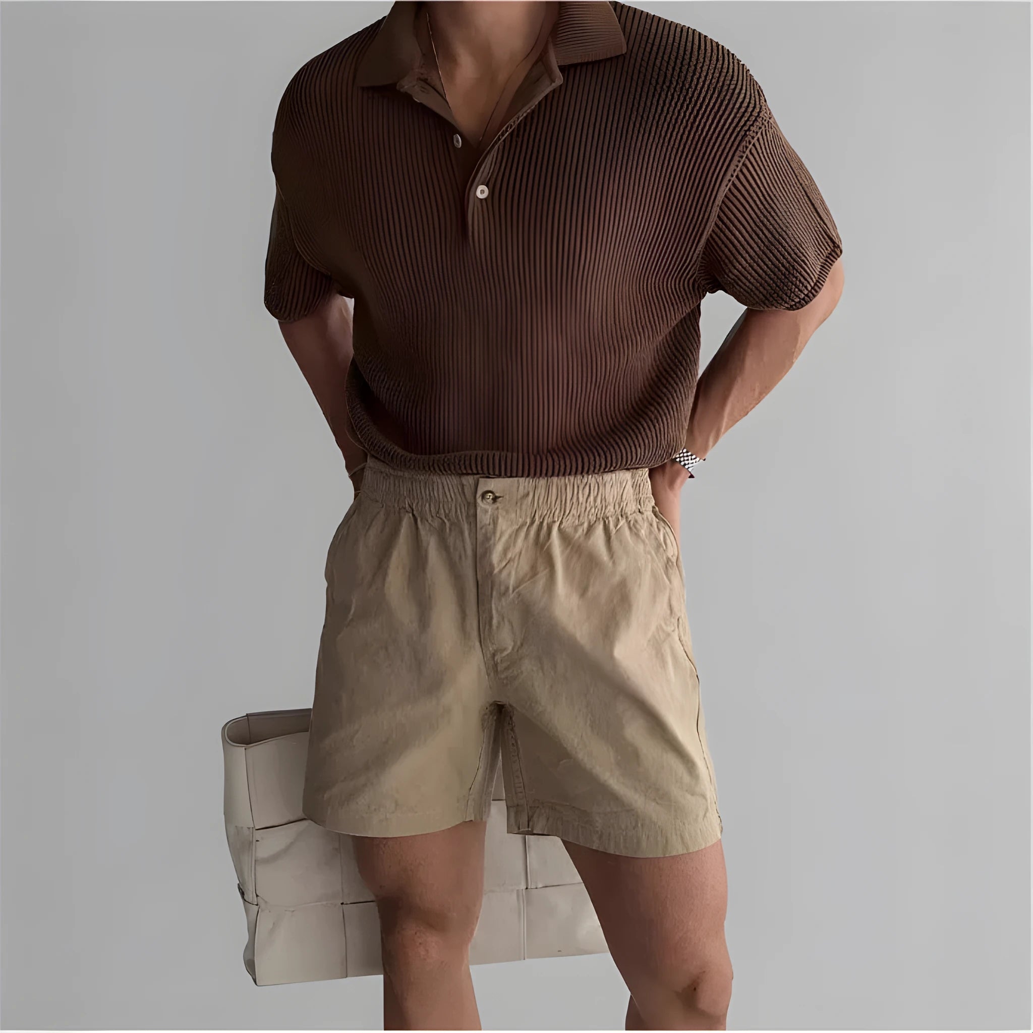 Man's loose-fit cotton sports shorts in khaki colour on a white background.