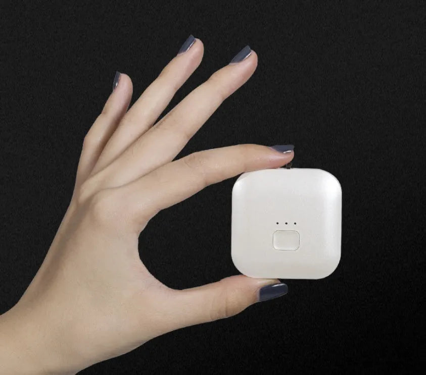 Mini USB portable air purifier necklace in pink, showing compact design with a wearable collar.