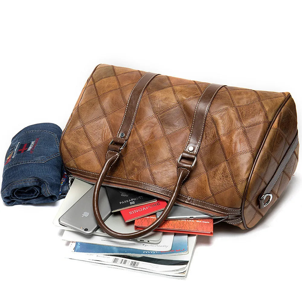 Vintage brown cowhide leather men's duffel bag with a single strap, shown open to reveal internal phone and ID pockets.