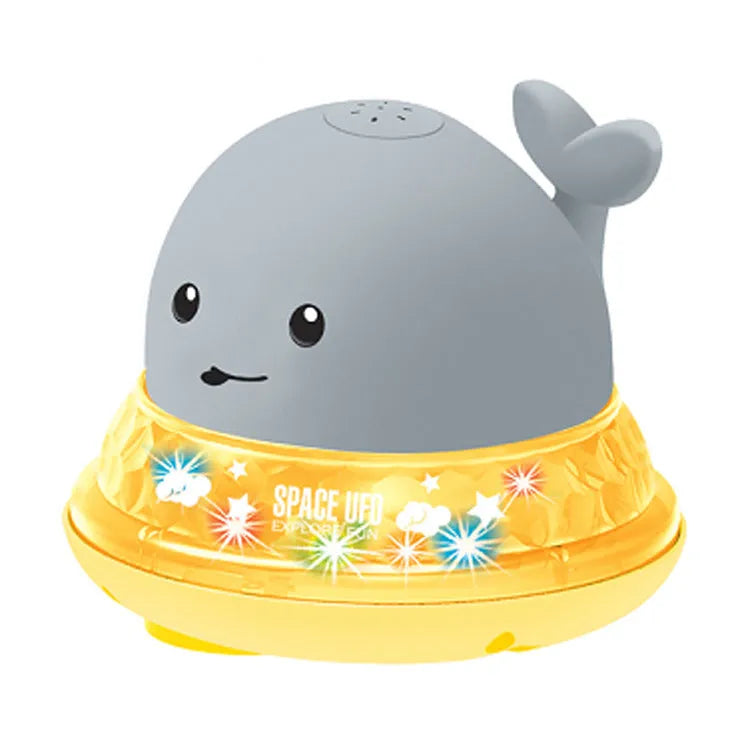 Electric whale-shaped baby bath toy with water spray, LED lights, and automatic water sensor