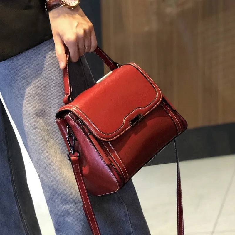 Women's brown genuine leather messenger bag with retro styling and multiple internal pockets