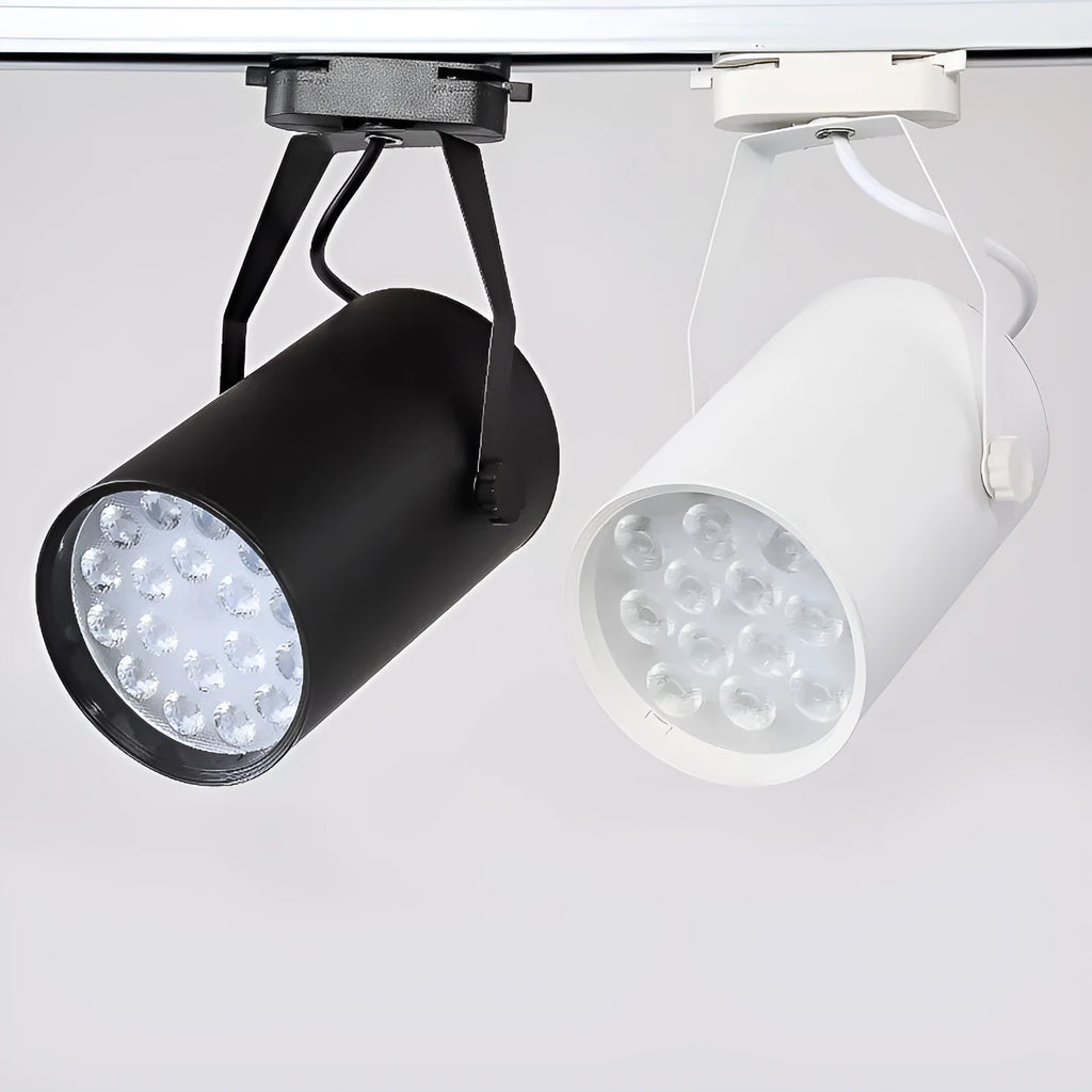 Black aluminium LED track spotlight with sliding head mounted on a track for wall lighting.