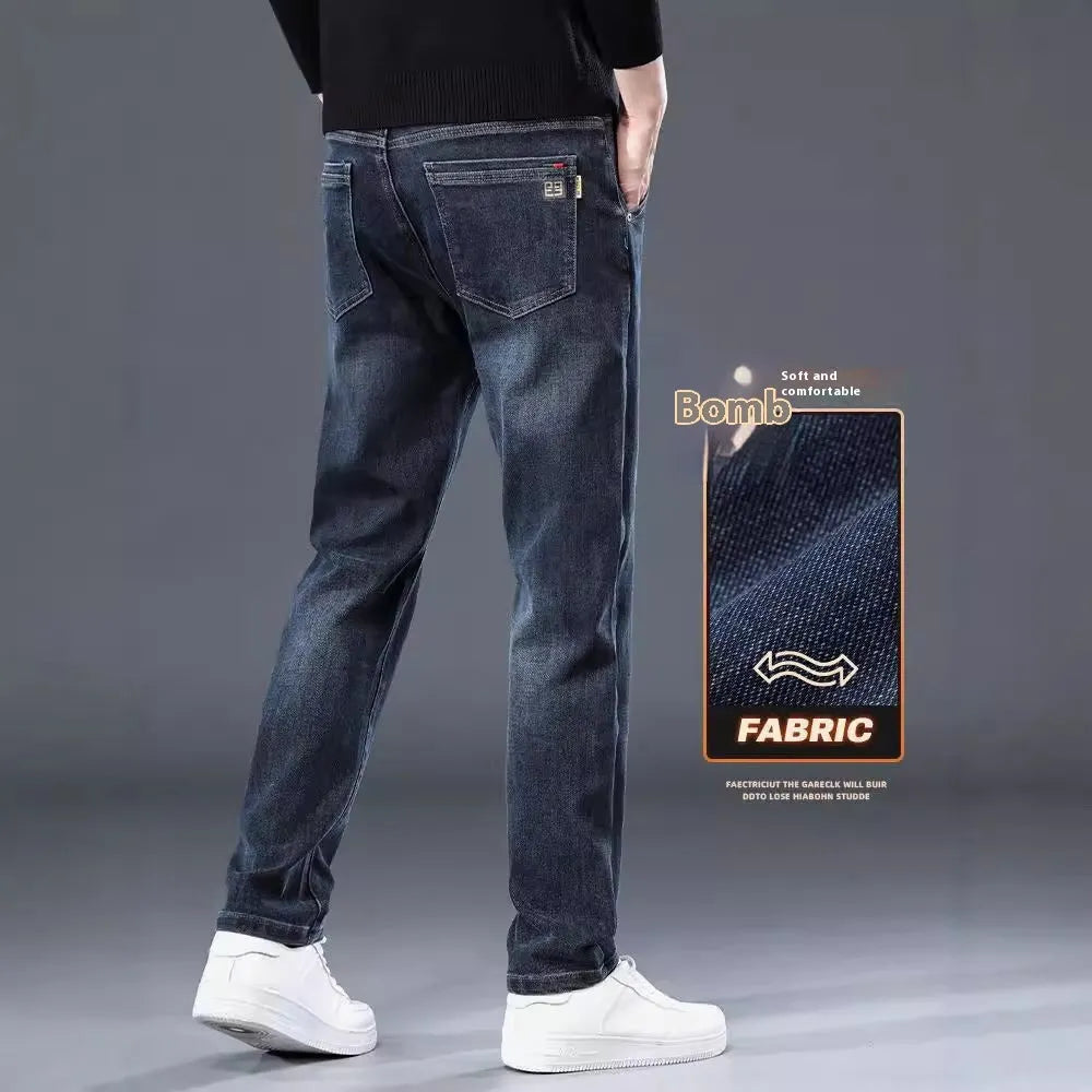 Man wearing slim straight blue grey casual trousers with a loose thin fit and zip fly.