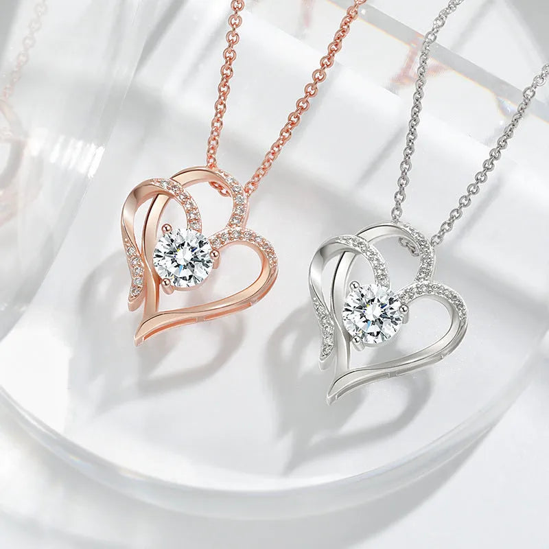 Women's heart-shaped silver necklace shown in rose gold, white gold, and yellow gold plating variations.
