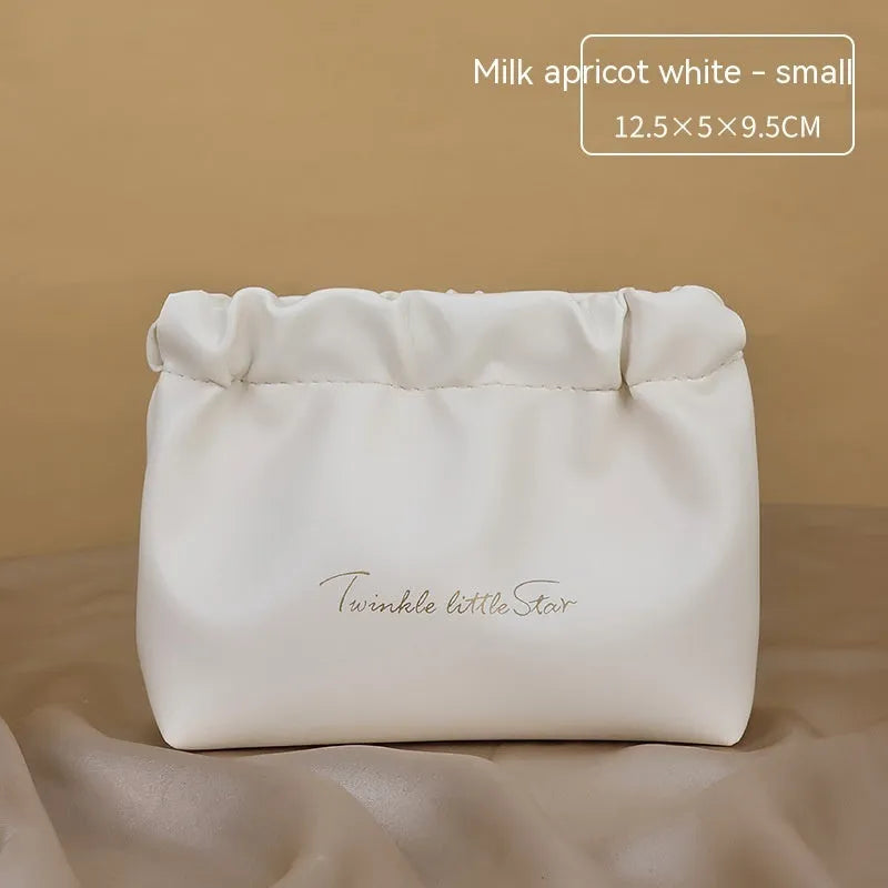 Leather travel toiletry bag in caramel mocha colour with large capacity and dry-wet separation compartments.