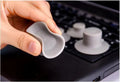 Set of four grey plastic laptop cooling pads: two large and two small, on a desk.