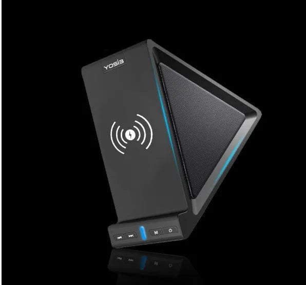 Black ABS Bluetooth speaker with integrated wireless charging pad and phone stand, shown on a desk.