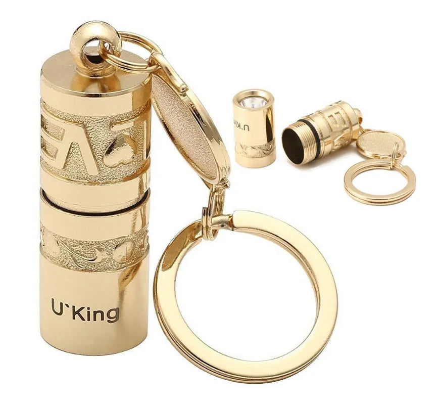 Gold-coloured zinc alloy waterproof mini LED flashlight on a keychain.