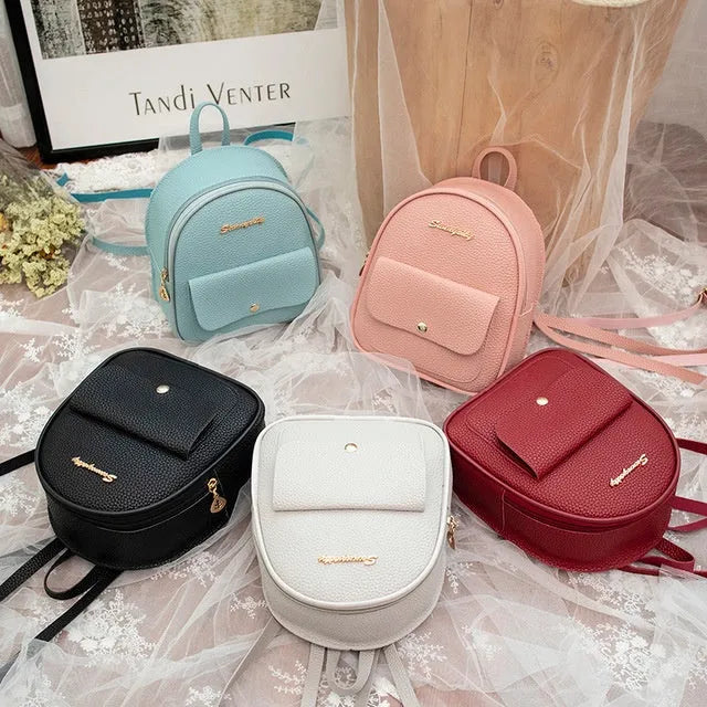 Women's black PU backpack purse with letter design and shoulder strap showing compact 18.5cm length
