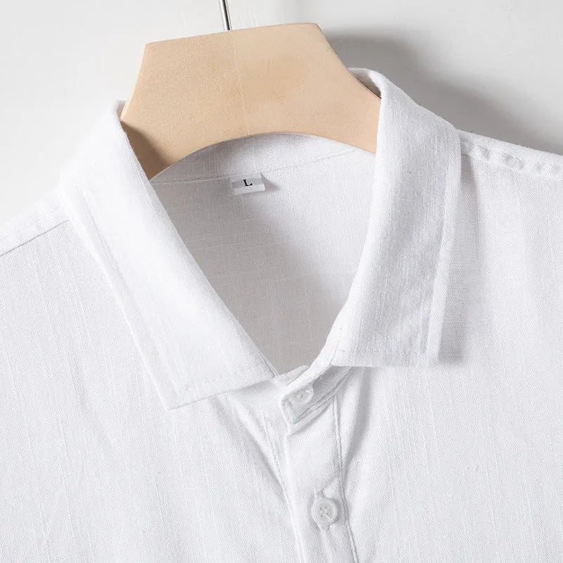 Men's loose-fitting linen-blend lapel t-shirt in black, shown on a model, highlighting the open collar and short sleeves.