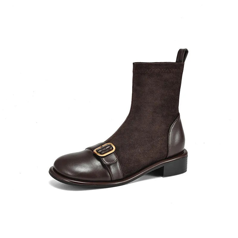Women's black low-heel Martin boots with belt buckle detail and front lace-up fastening.