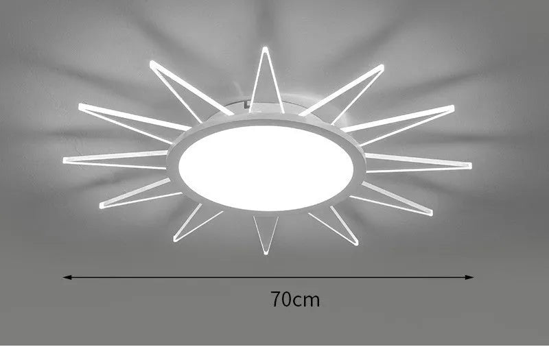 Modern round aluminium LED ceiling lamp with a white shade on a ceiling.
