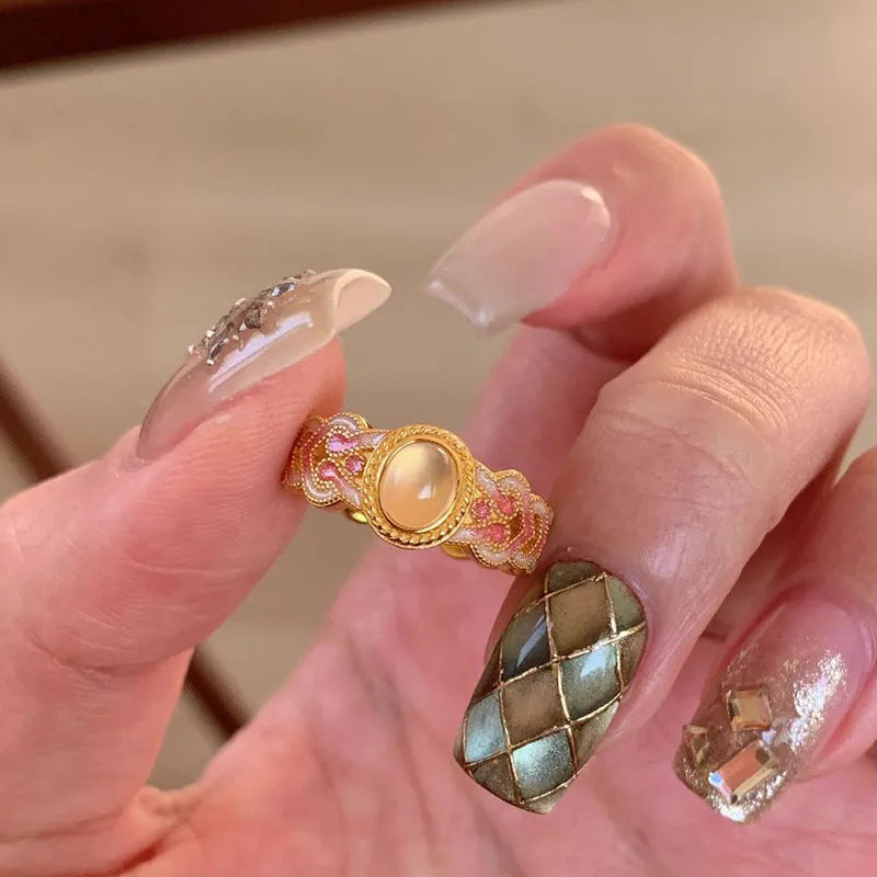 Geometric pink crystal enamel open ring with gold plating showing adjustable design