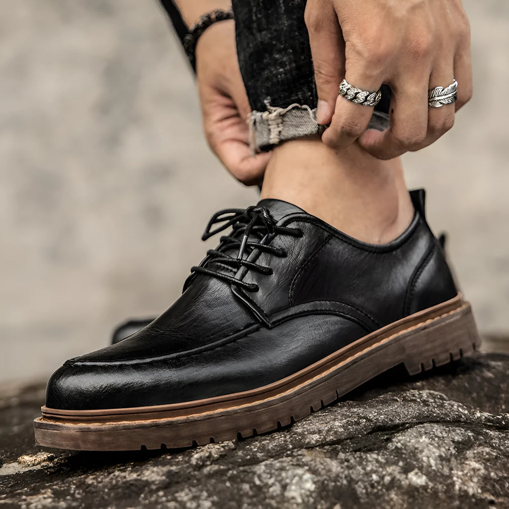 Men's black and brown casual leather shoes with round toe, low top, and flat rubber sole