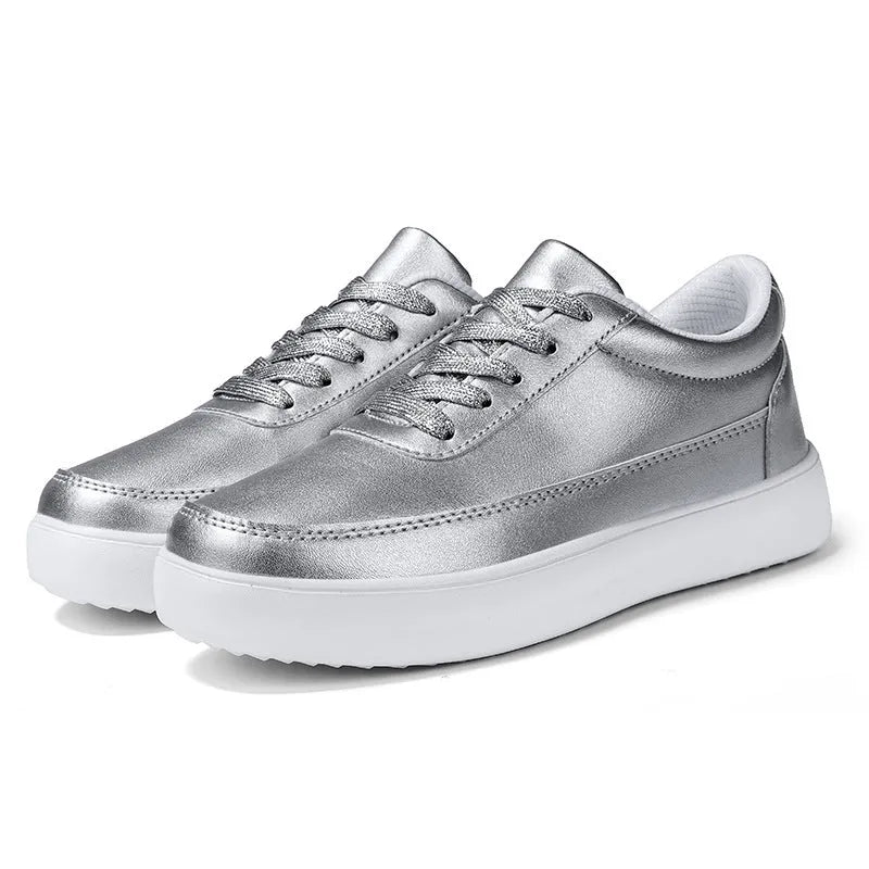 Women's white leather flat casual shoes with front lace-up closure.