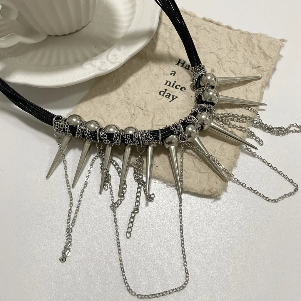 Women's leather necklace with winding rivet beads and a tassel in casual style.