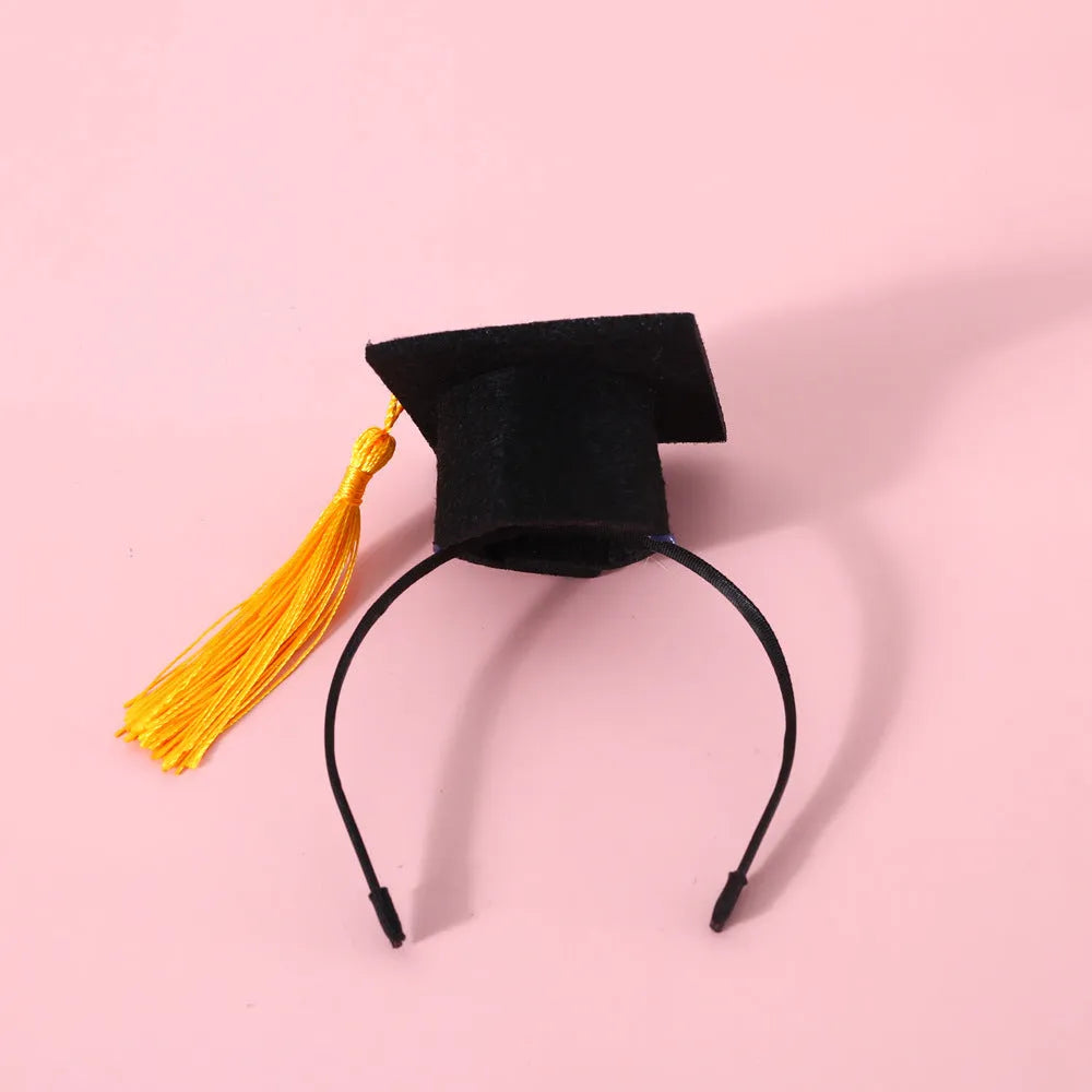 Small pet wearing an elastic wool felt hair band and matching doctor's degree bow tie.