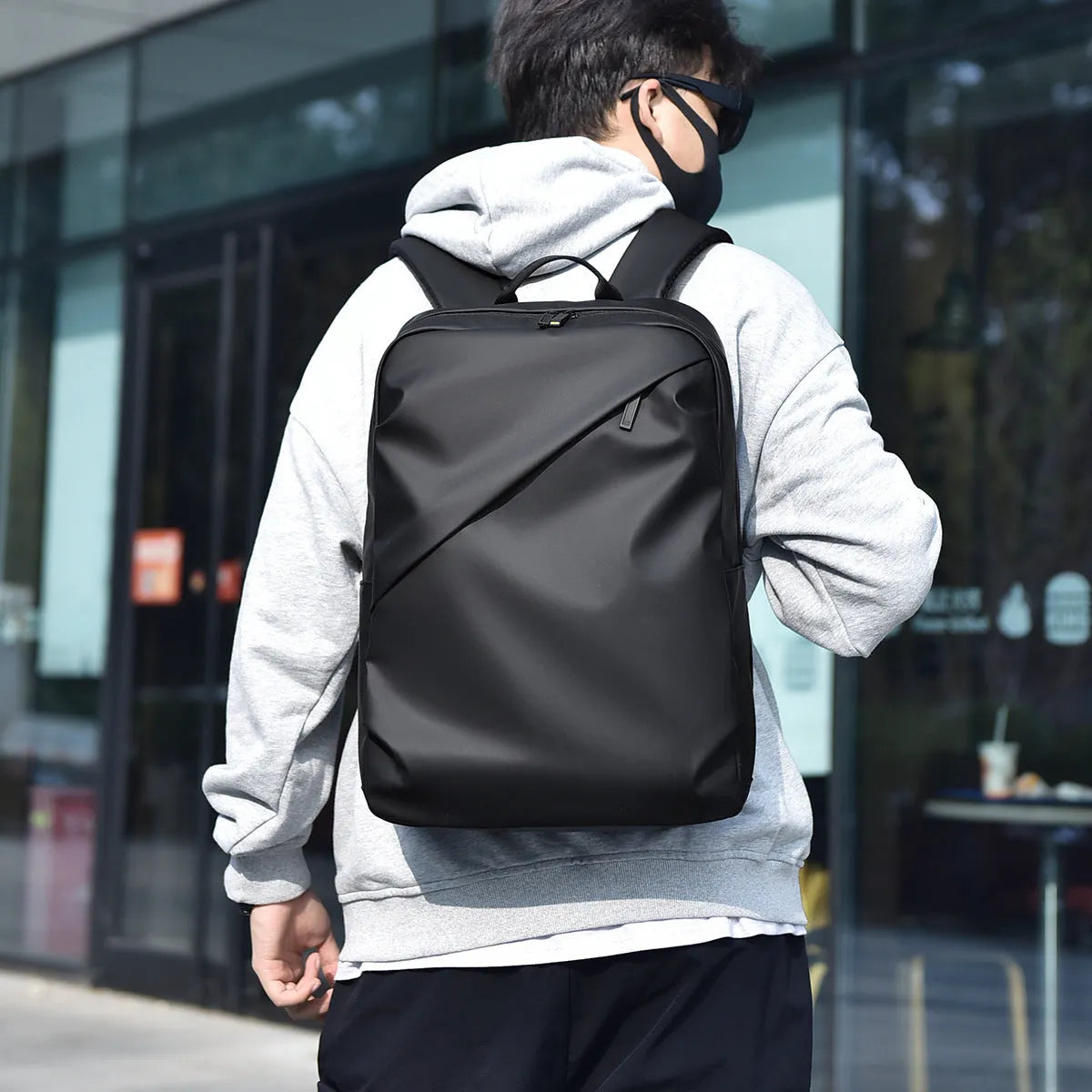 Men's large waterproof PU backpack in black, blue, or grey showing sewing thread details