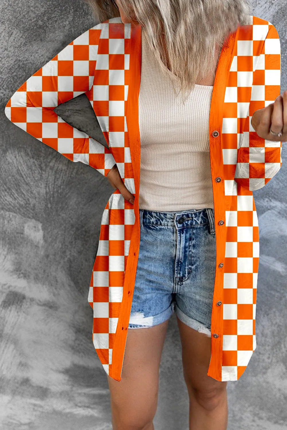 Women's long grey plaid pattern knitted cardigan coat with regular sleeves, shown on a model.