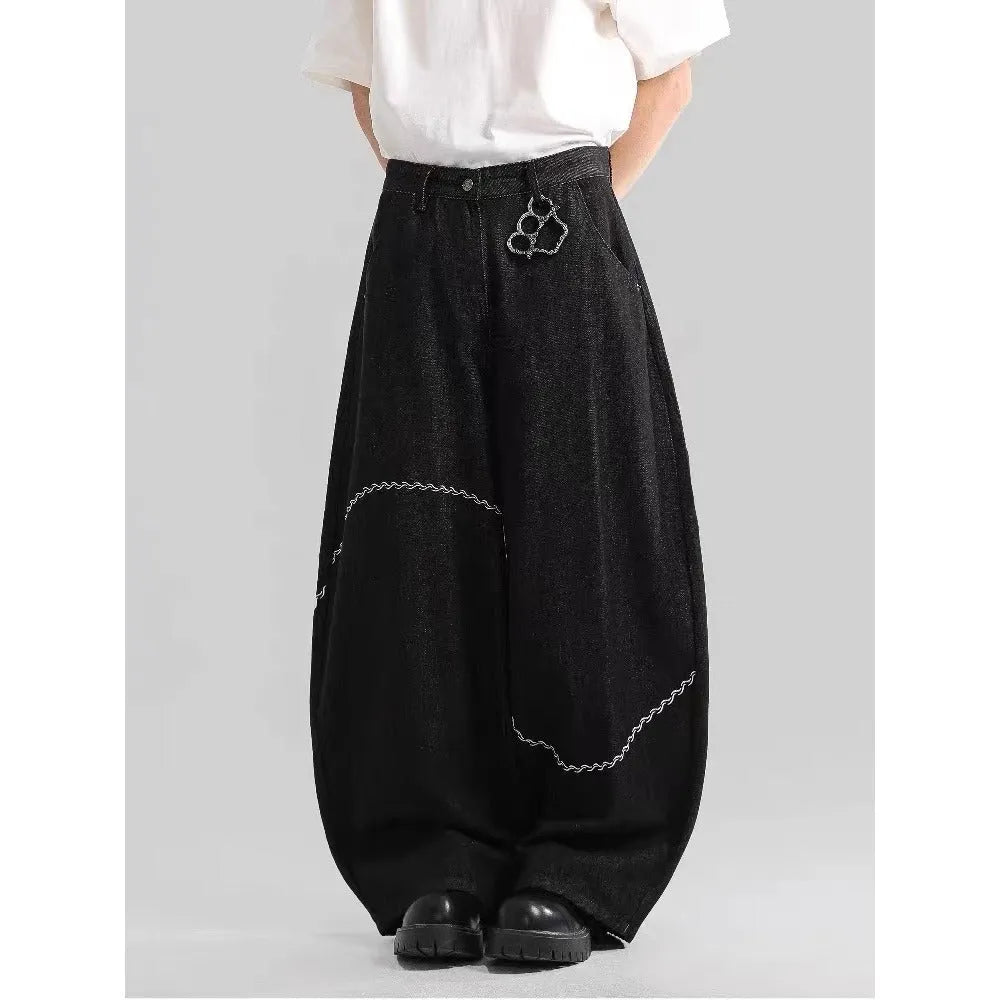 Black straight-leg denim trousers with a mid-waist and zip fly on a mannequin.