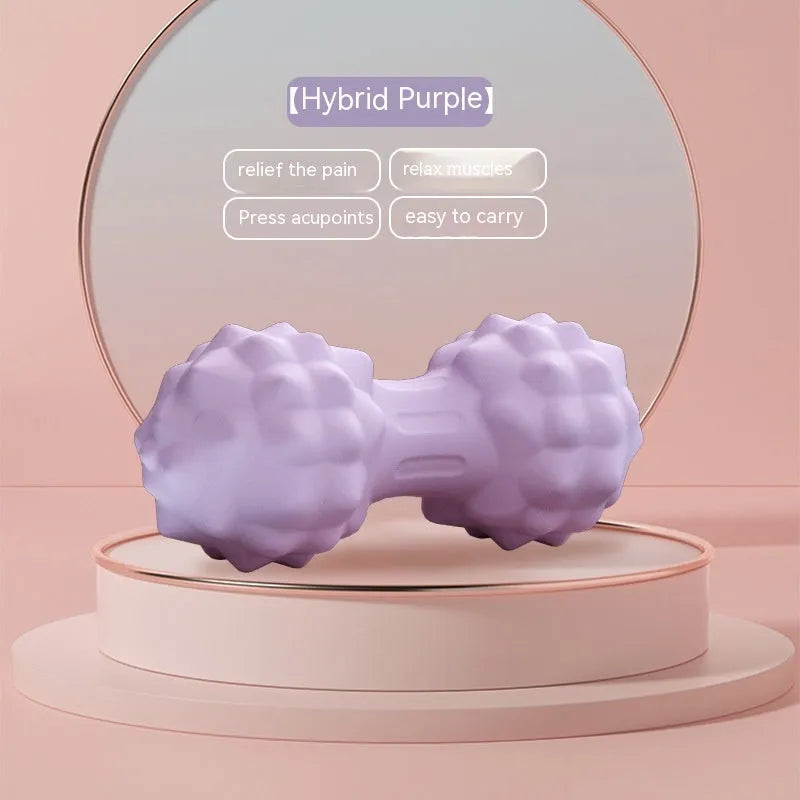 Blue peanut-shaped TPR foot massage ball on a wooden floor.