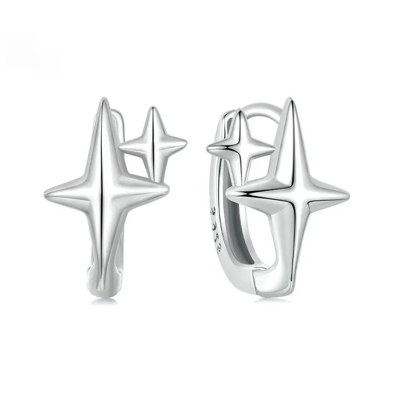 Sterling silver minimalist star design clip-on earrings with XINGX detail and oxidation finish.