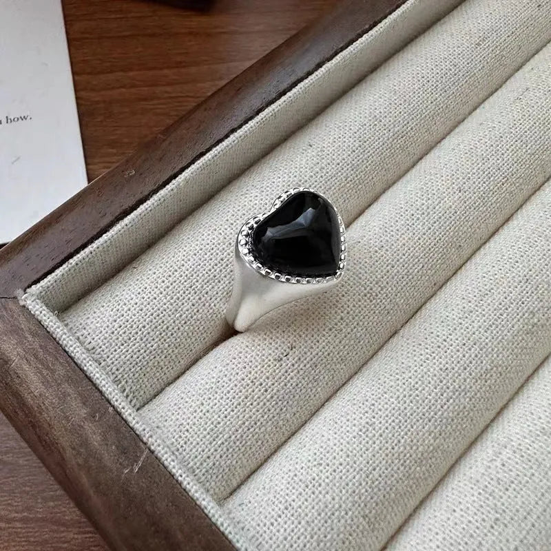 Adjustable open-mouth sterling silver ring with a black heart-shaped agate stone.
