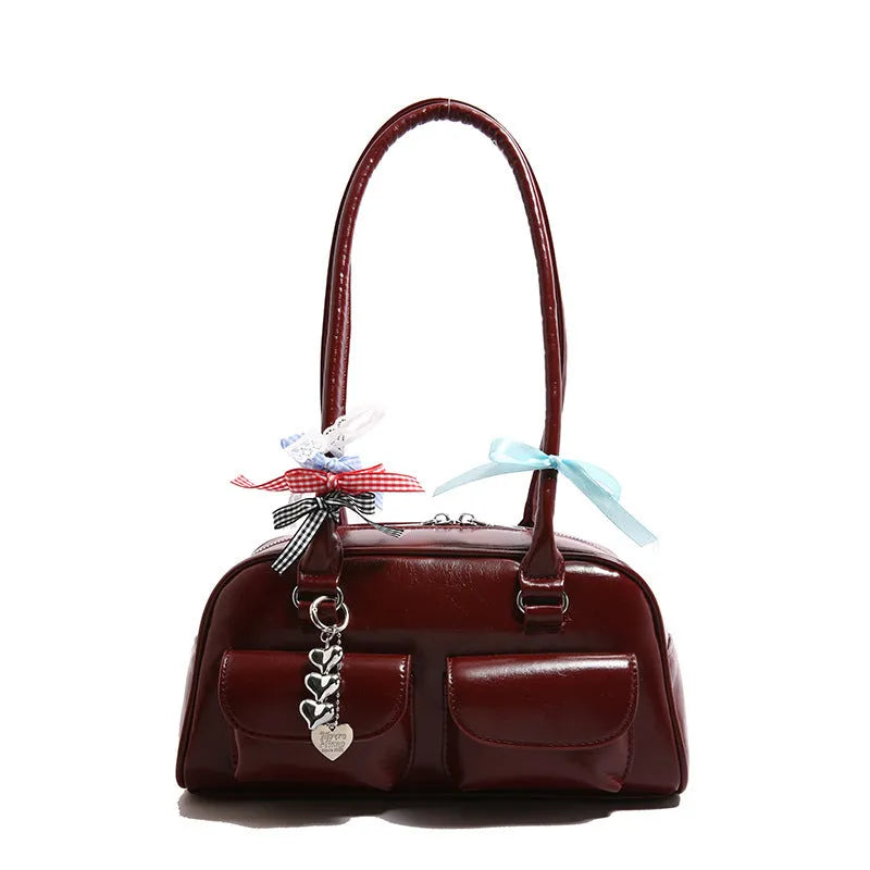 Retro pillow-shaped women's PU leather shoulder bag in black with double straps and flap closure.
