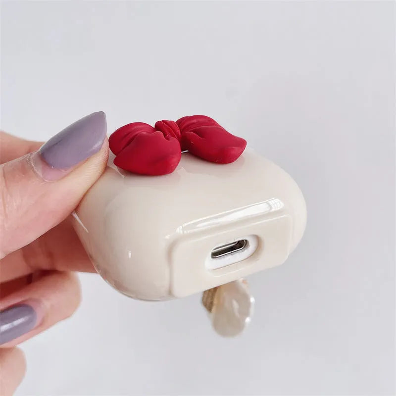 Beige red bow shell TPU AirPods protective case showing clamshell design