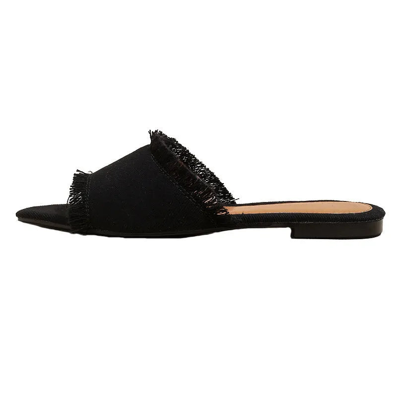 Women's denim casual flat slippers with a tassel detail in multiple colour options.