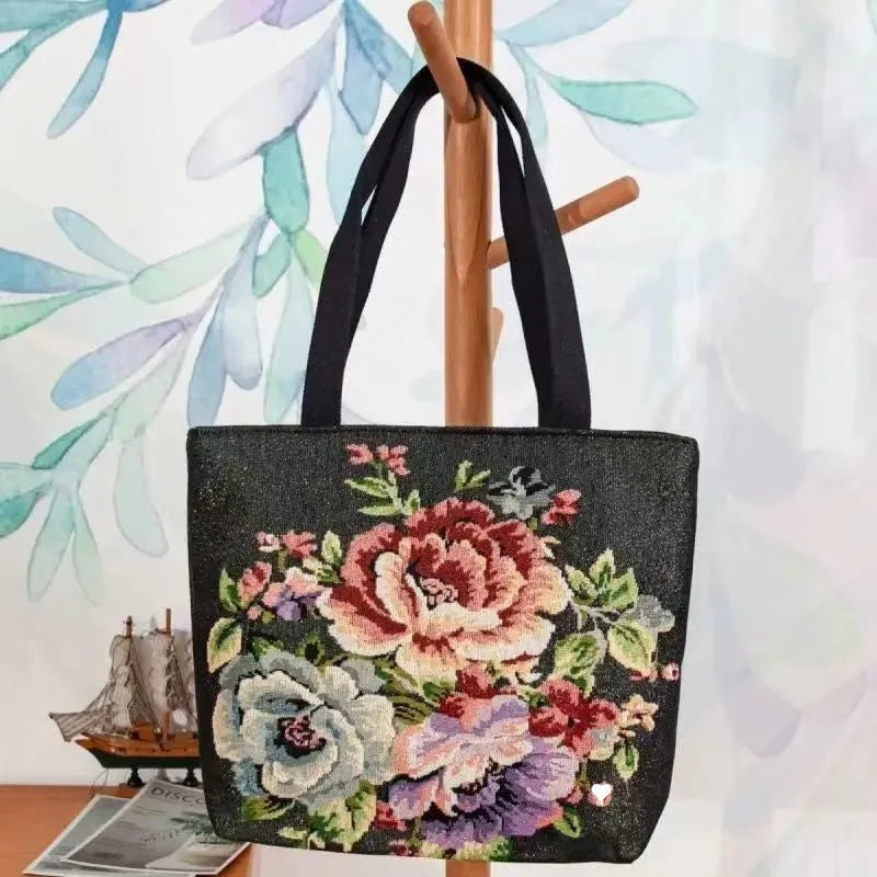 Handheld canvas bag with gold wire embroidery, shown in one of seven colour designs.
