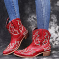Women's blue embroidered cowboy boots with a wedge heel and pointed toe