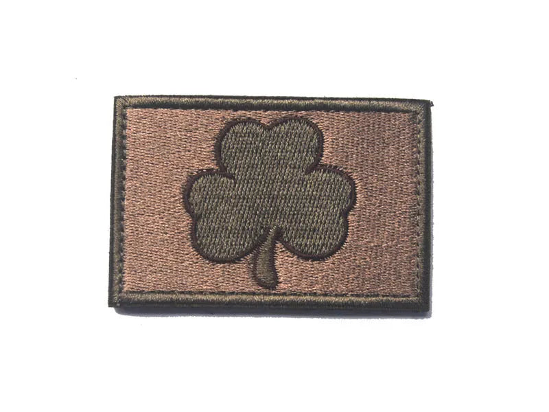 Outdoor embroidered fabric badge with Velcro strip backing on a green clover design.