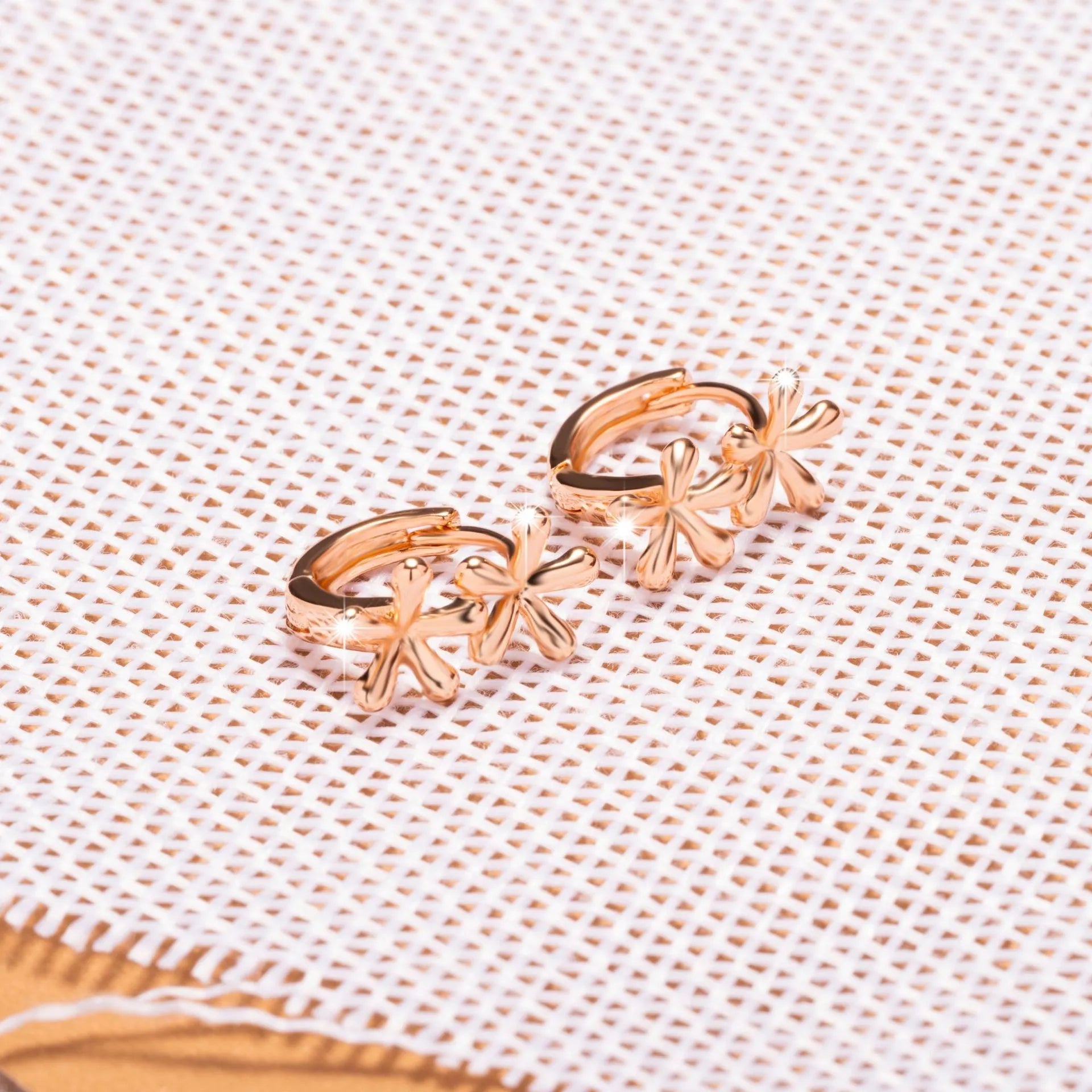 Rose gold circular stud earrings with a waterdrop flower design for women.