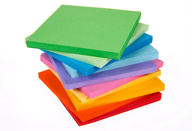 Assorted colourful paper scrolls with metal eyelets for messages and craft projects.
