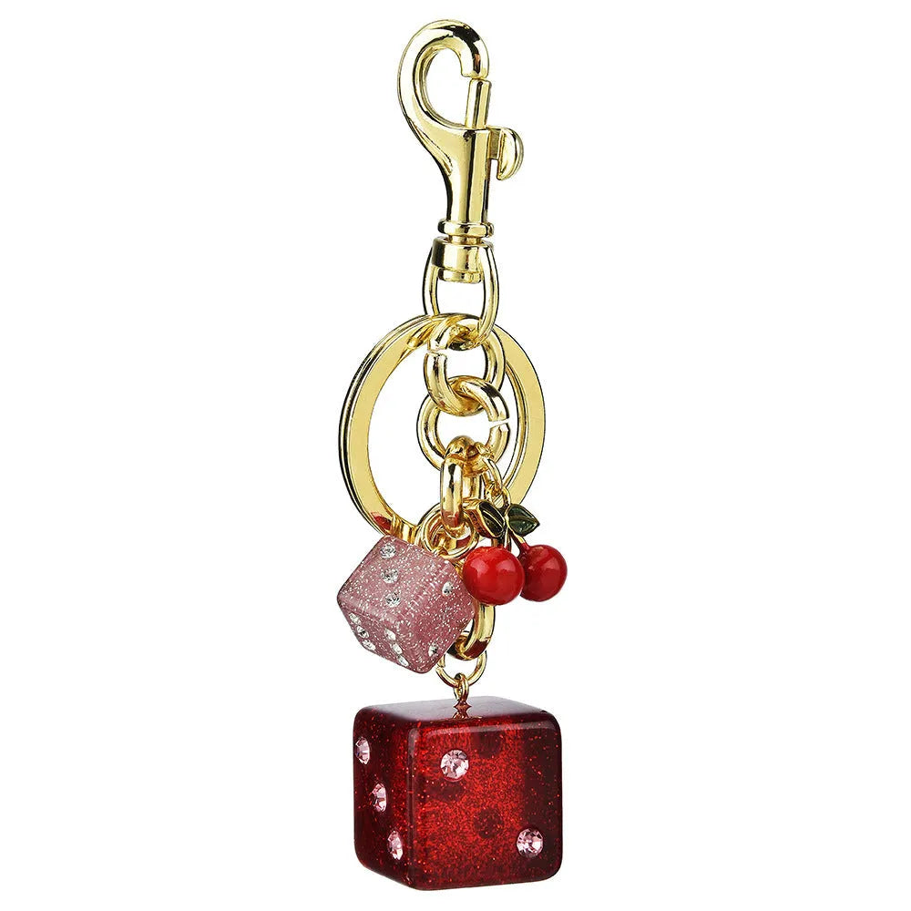 Square cherry two-tone dice keychain pendant on a metal ring.