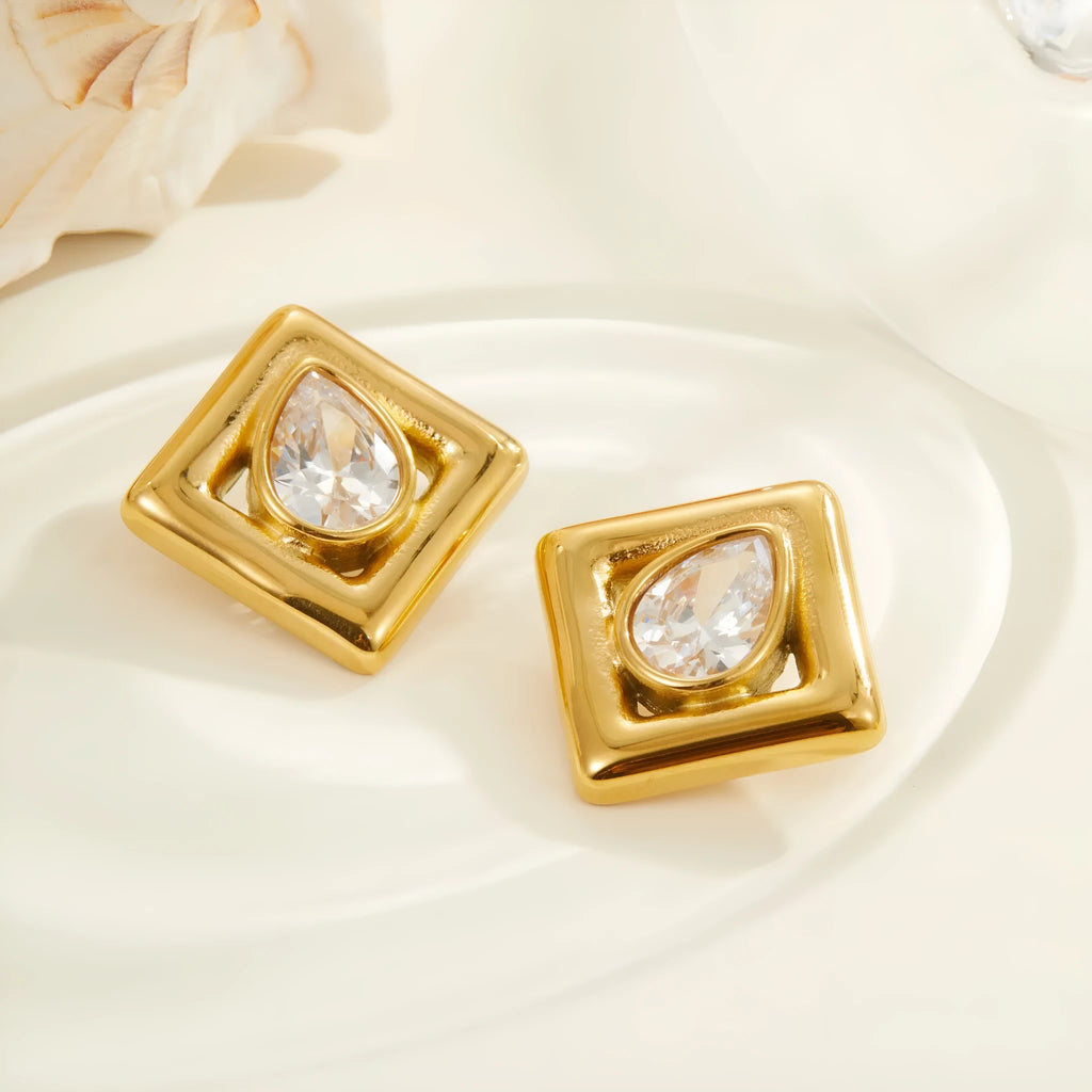 Gold geometric stud earrings with inlaid water drop zircon on white background.
